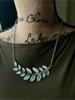 Silver necklace with green leaf pendant